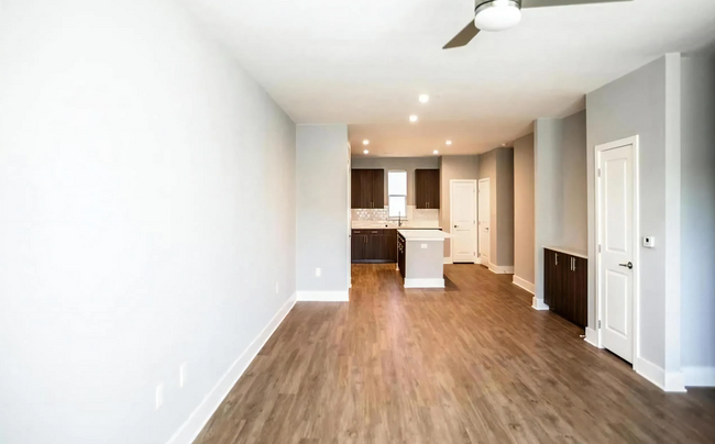 open concept living room with hardwood floors - 4000 Orchid St