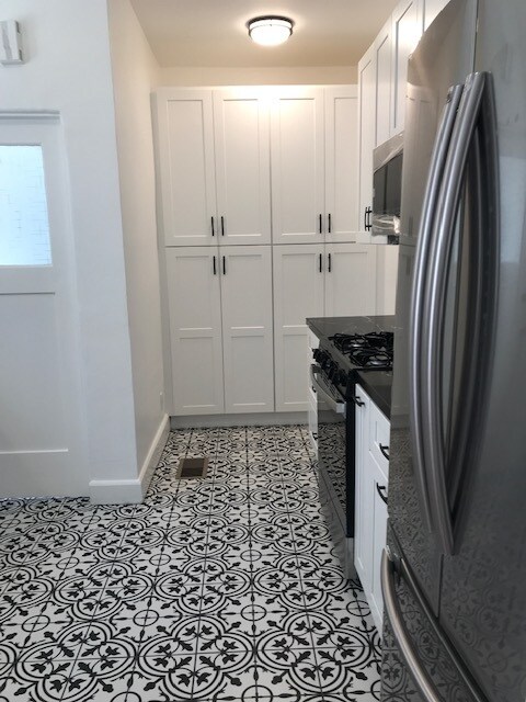 kitchn pantries and door to washer dryer - 916 S Orange Grove Ave