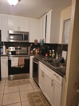 Kitchen with full shaker cabinets and stainless steel appliances - 4215 N University Dr