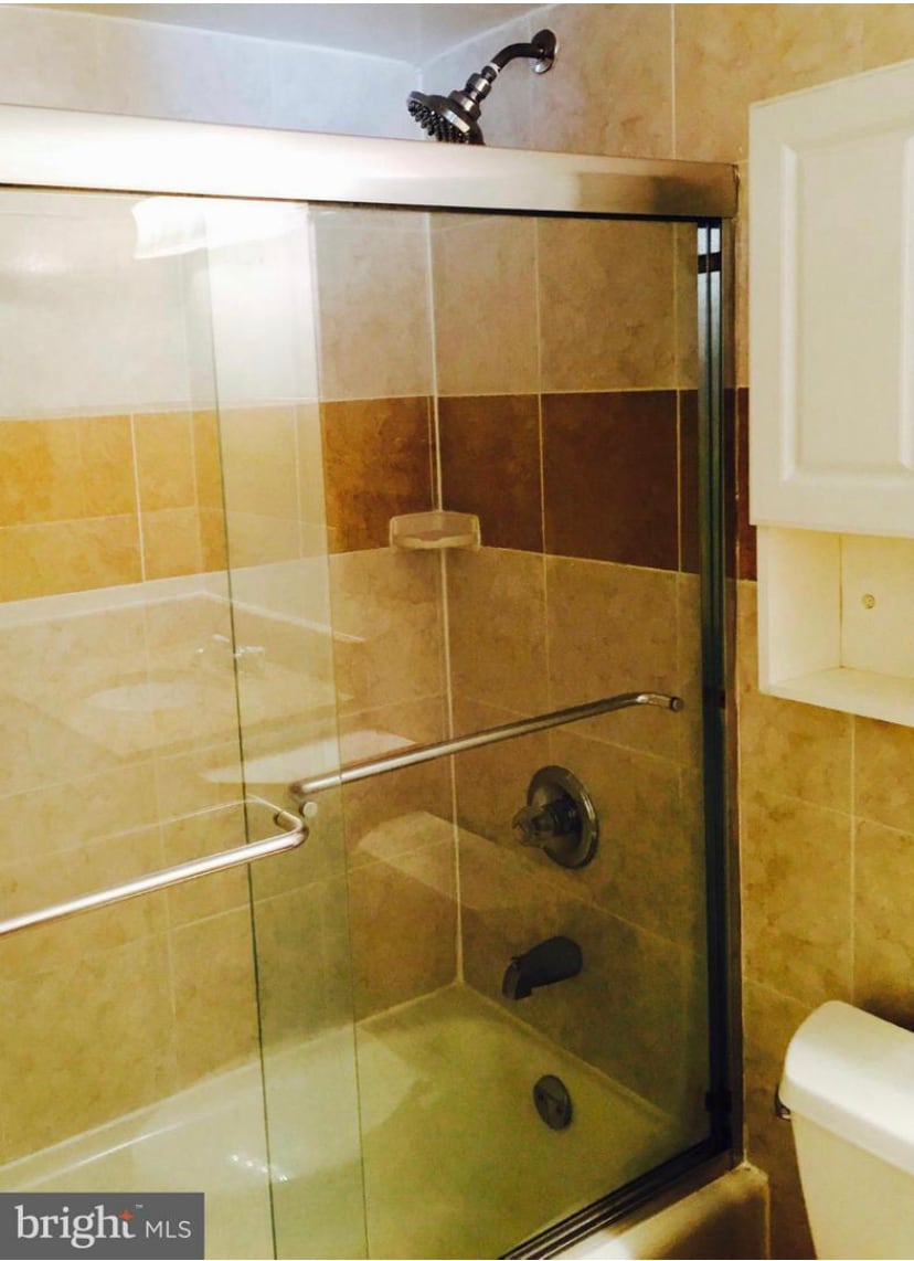 Glass shower door with tub - 2939 Van Ness St NW