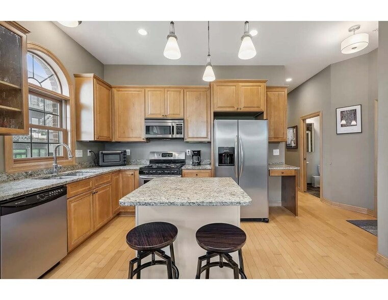 View of granite countertops and maple cabinets in kitchen, island unit - 3125 Inglewood Ave S
