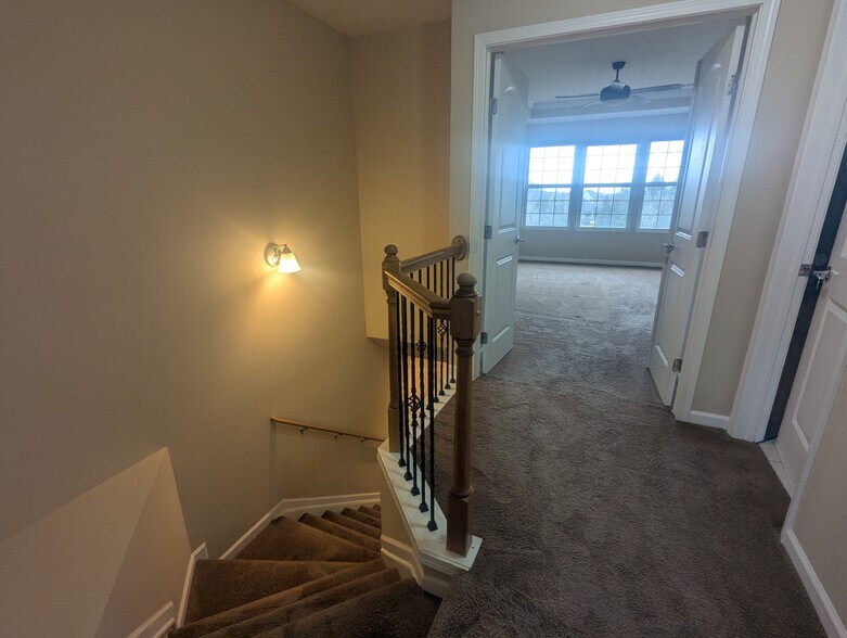 Entrance into the primary suite with an additional bathroom on the right - 6465 Park Pointe Ct
