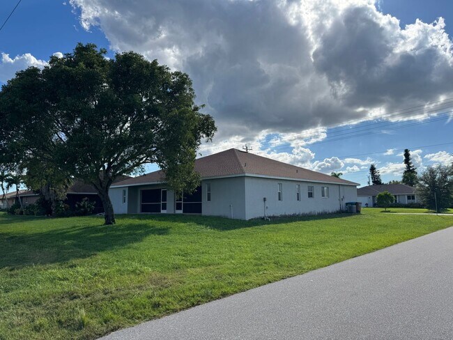 Building Photo - Experience this Cape Coral 3 bedroom 2 bath corner duplex with 1 car garage and screened in lanai.
