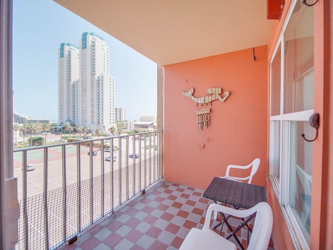 Patio with north view of island and tennis courts - 130 Padre Blvd