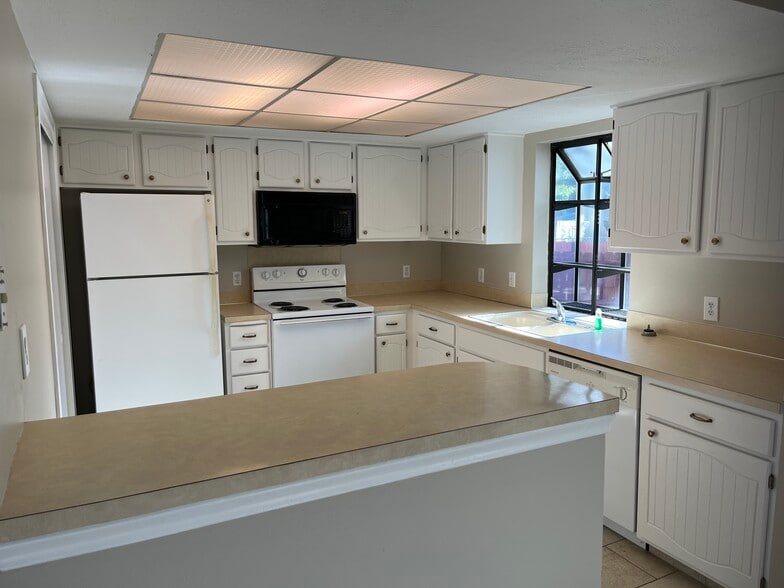 just painted kitchen cabinets 10/2025. Also, has a wonderful garden window for plants/herbs - 12063 Burdette Cir