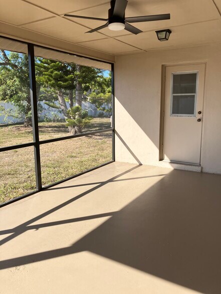 Screened lanai with ceiling fan and painted floor - 3712 SW 5th Pl