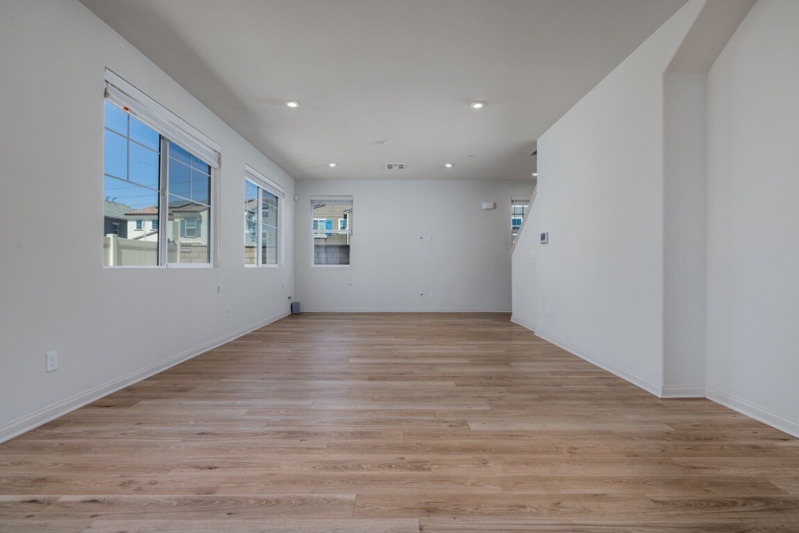 Another angle of the open living area showcasing bright natural light - 26549 Brightstone Dr