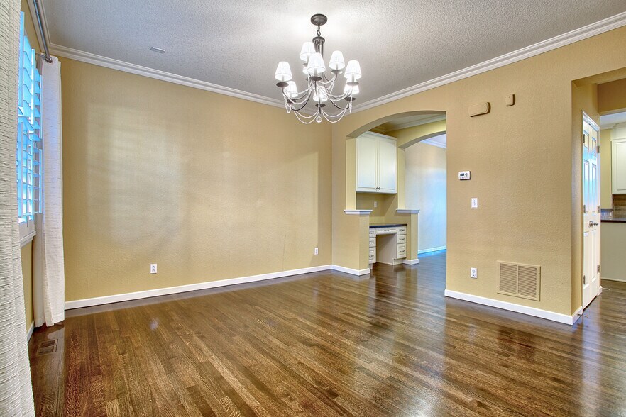 Living room with hardwood floors, plantation shutters, crown molding, chandelier - 7422 E 7th Ave Unit 14