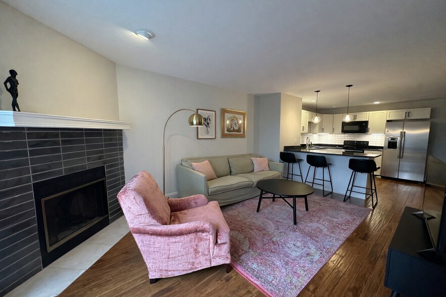 Open living space with a classic wood-burning fireplace. - 524 Superior St