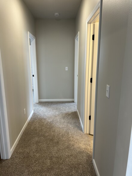 Downstairs hall to beds and family room - 5940 S Coneflower Ave