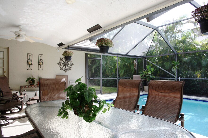 Patio has space for plenty of seating poolside and two ceiling fans - 2662 NW 42nd St