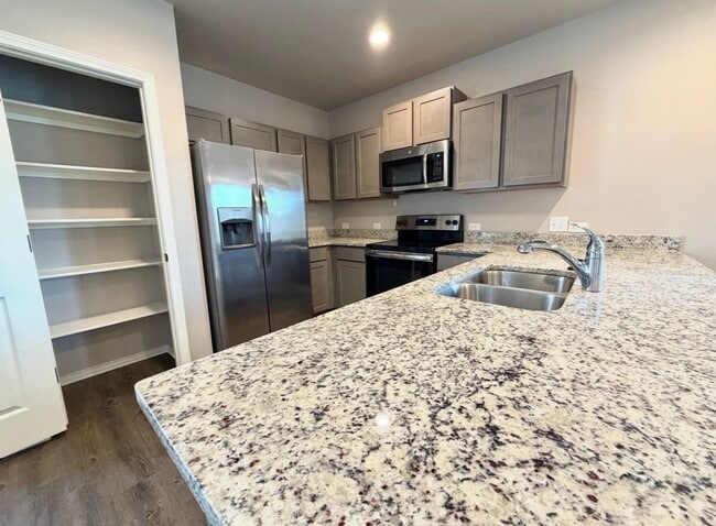 Building Photo - Corner Unit Townhome with 3 Bedrooms, Garage & Private Yard