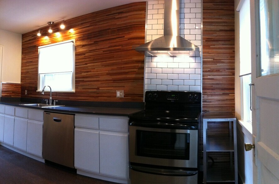 designer kitchen / custom wood wall / subway tile / stainless appliances and range hood - 4811 NE 31st Ave