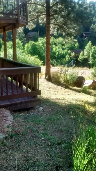 Lower deck with upper deck above sitting on the edge of 200 acres of open space. Small playground and summer volleyball court nearby. - 120 Wisp Creek Dr