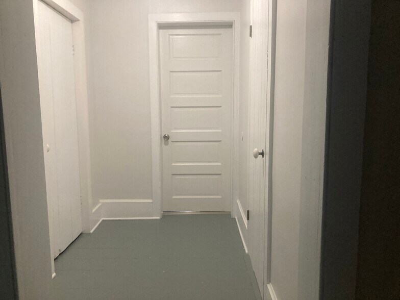 Hallway with two large closets with shelving, show rack. - 35 Main St