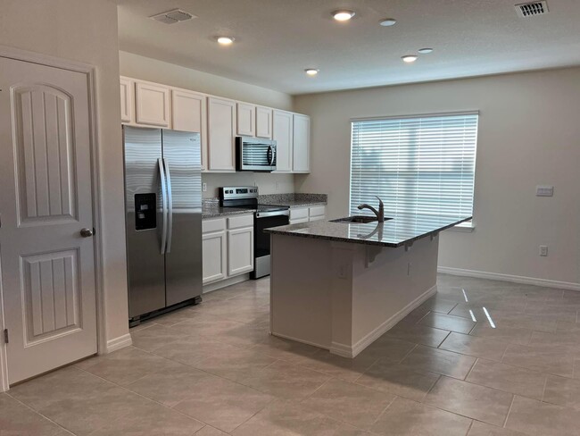 Kitchen with stainless steal appliances - 13483 Sagestone Dr