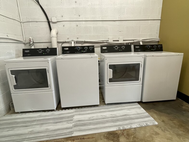 Double washer and dryers in laundry room. - 475 S Hickory St