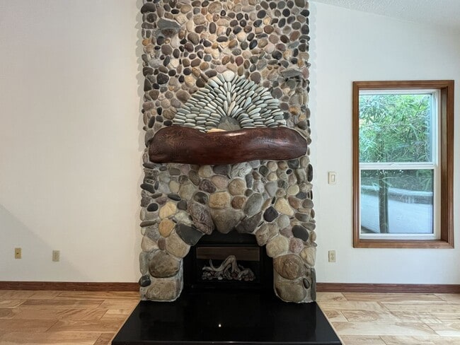 Building Photo - Spacious 3-Bedroom Home with Custom Stone Fireplace, Attached 2-Car Garage & Expansive Backyard i...