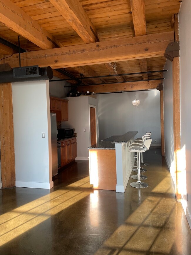 Kitchen with island opens to living space - 6533 E Jefferson Ave