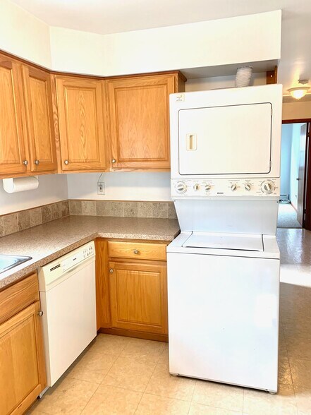 Kitchen showing dishwasher, washer and dryer; cabinets are oak - 203 5th St