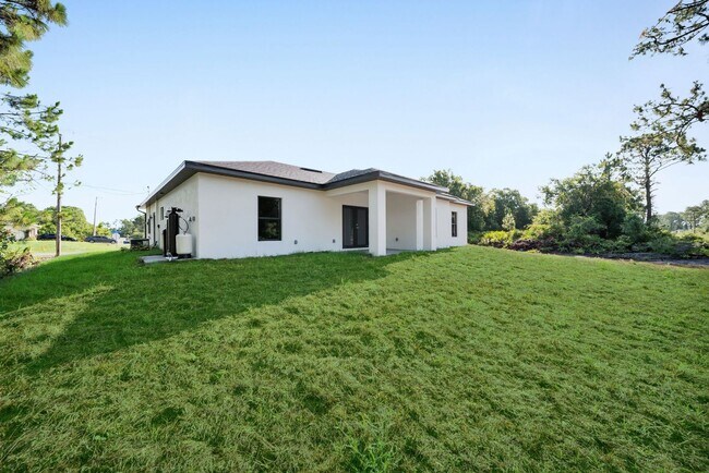 Building Photo - Brand-New Home in Lehigh Acres – Move-In Ready! FL 33974. Qualify for a deposit-free option and s...