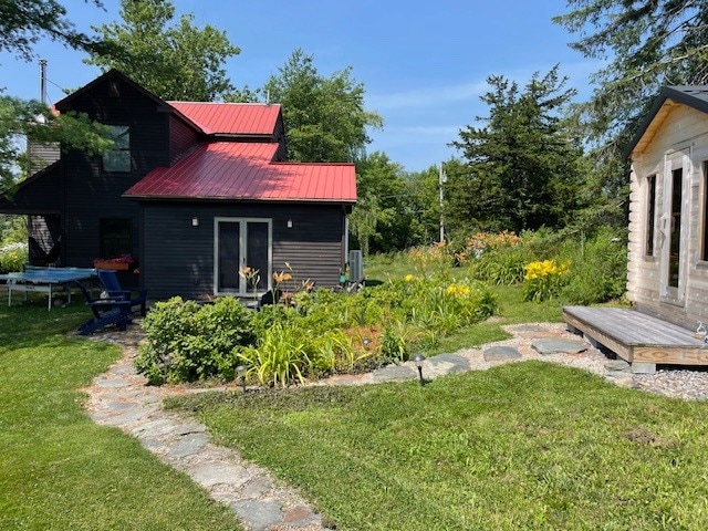 Rear view with stone steps to sauna. - 223 Huntley Rd