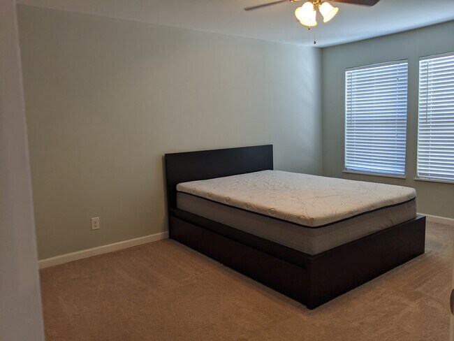 The master bedroom is generously-sized with plenty of space and a great view. - 2414 Lake Park Rd