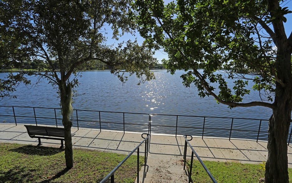 Tranquil lakeside seating perfect for a quiet moment or scenic stroll. - Bridgewater at Lake Osborne