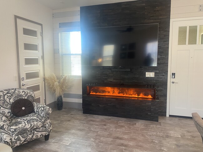 Custom deco wall and water vapor fireplace and 84” tv - 19848 W Monterosa St