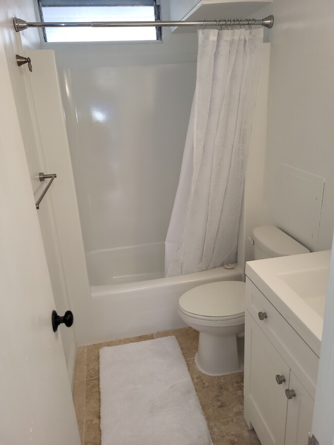 renovated bathroom with new cabinet and mirror - 441 Lewers St