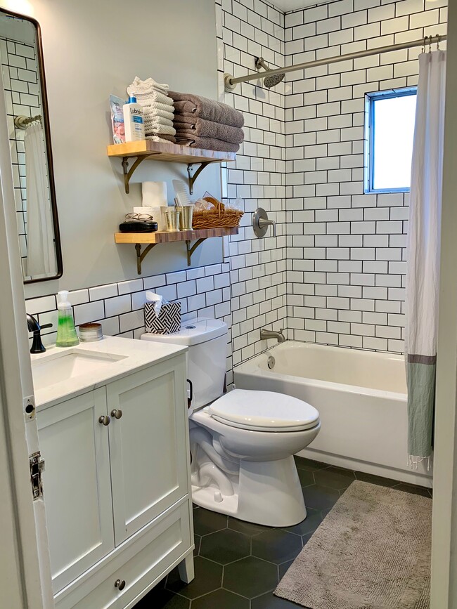 Bathroom with tub shower and brand new window with obscured glass - 900 N El Molino Ave.