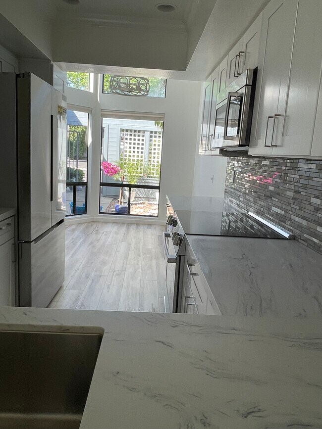 Kitchen to kitchenette to courtyard - 811 Spindrift Dr