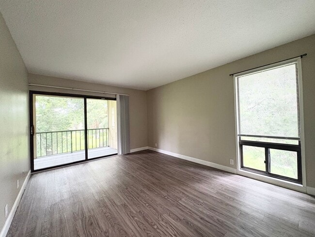 Building Photo - Beautiful Corner Unit with Vinyl Plank Flooring & Private Screened Patio
