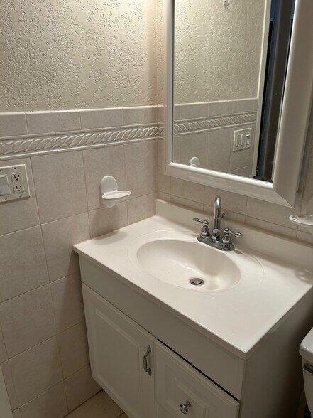 white bathroom with tons of storage - 630 NW 7th Ave