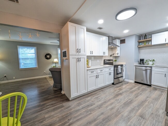 The kitchen has been recently renovated with modern amenities, stainless appliances, a dishwasher, l - 4107 Crane St