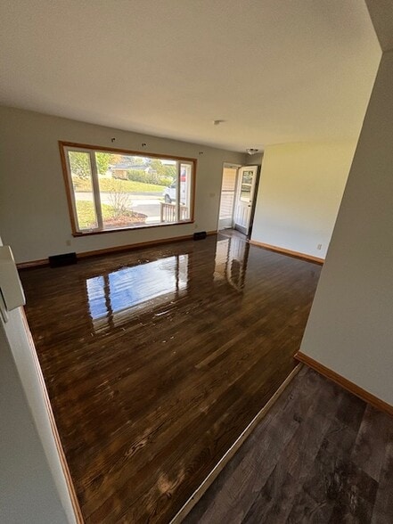 Front living room with freshly varnished hardwood floors - 409 Hill N Dale Cir