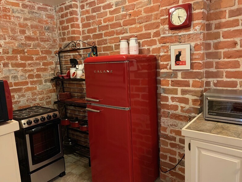 New fridge and stove with cookware - 4036 Saint Charles Ave