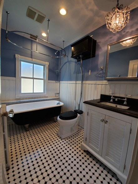 Bathroom with claw foot tub high tank toilet - 78 S Carll Ave