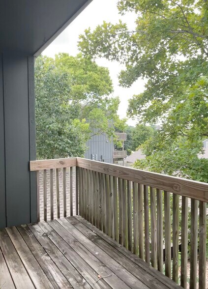 The spacious covered deck overlooks a large, beautiful tree - 12743 W 110th Ter