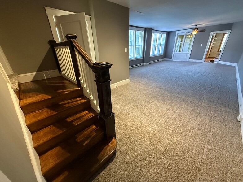 Entry area with living room and steps to bedrooms - 218 E Orange St