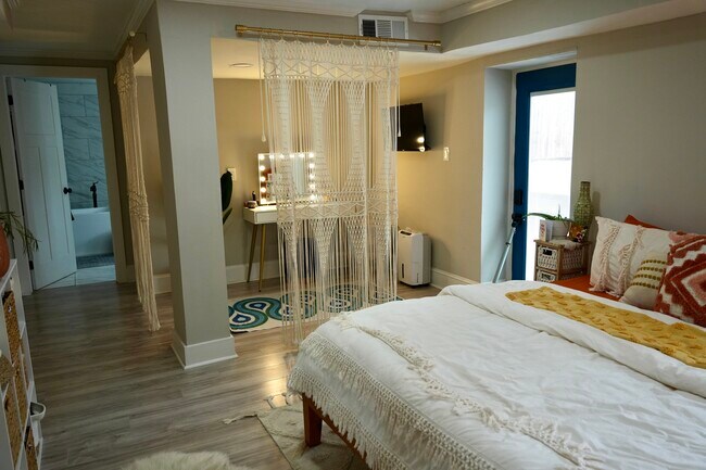 Master bedroom furnished with king bedframe and tv - 1532 Belva Ave
