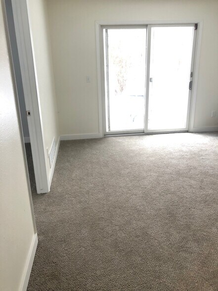 living room space in the basement with walkout to backyard - 6228 Magnolia Ln N