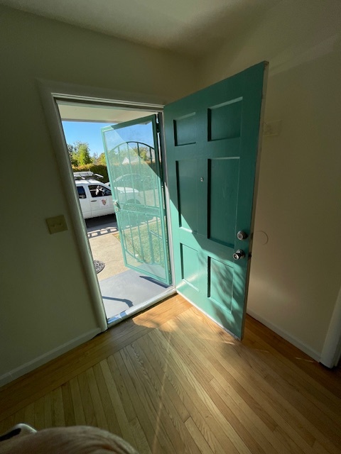 Newly painted front door opens into refinished hardwood floors. - 3731 46th St