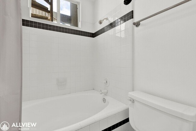 Building Photo - Spacious Coastal Condo with Rooftop Ocean ...