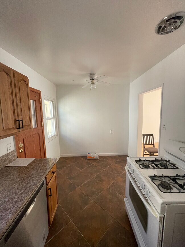 Spacious Kitchen with Granite counter tops and solid wood cabinets, porcelain tile floor - 10513 Crenshaw Blvd