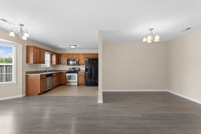 Building Photo - House with Fenced Back Yard Available!