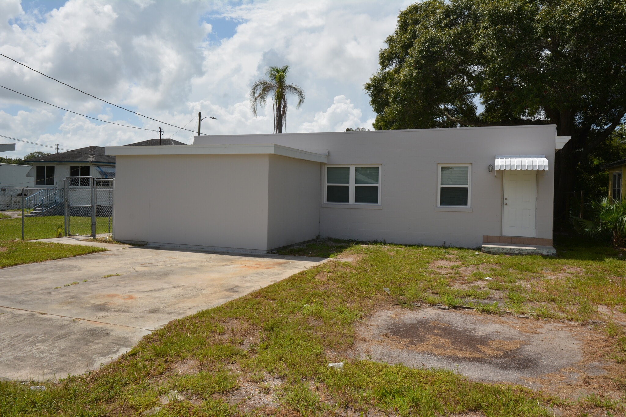 Back of unit with separate entrance to one of the bedrooms and parking - 5009 TANGERINE AVE S