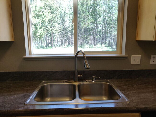 Building Photo - Charming 4-Bedroom Home on 1/2 Acre with a Fenced Backyard, Fully Insulated Double-Car Garage, in...