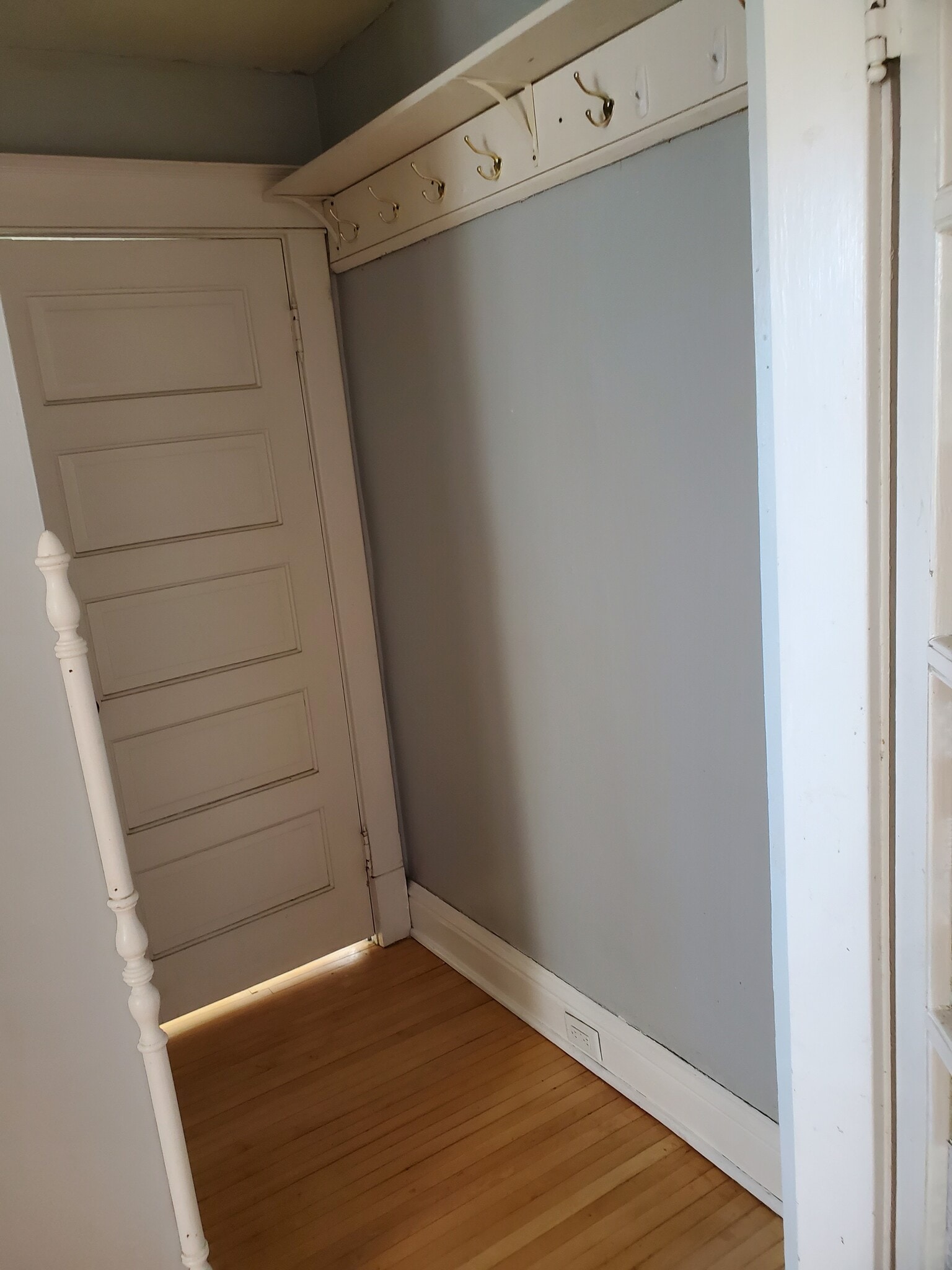 hallway to bathroom with light grey walls - 606 7th St N