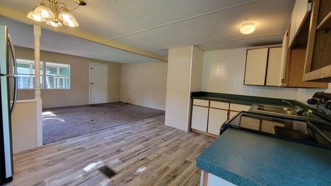 Building Photo - Freshly painted spacious 2-bedroom 1-bath home with a screened porch and storage shed.